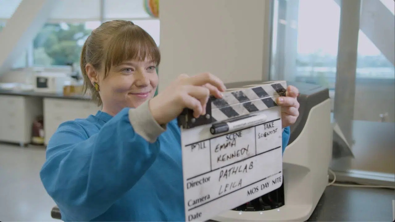 Why-we-use-the-clapper Lab employee holding video clapper before an interview