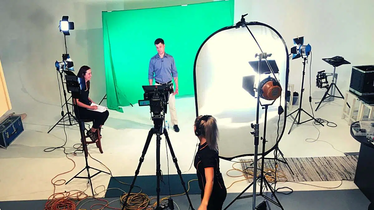 Are you being filmed in front of a green screen Man in blue short being filmed in front of a green screen<br />