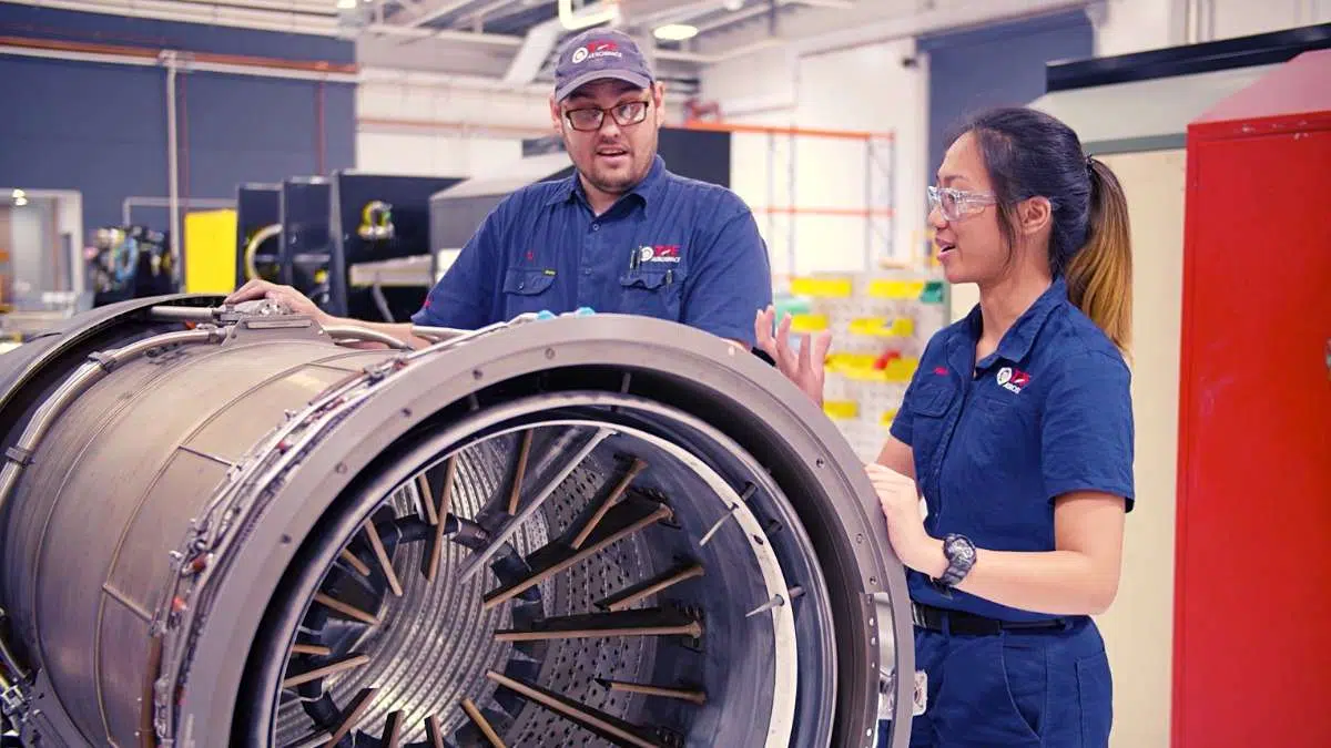 Recruitment video production 1 Male and female cummins employees in a recruitment video scene working on an engine