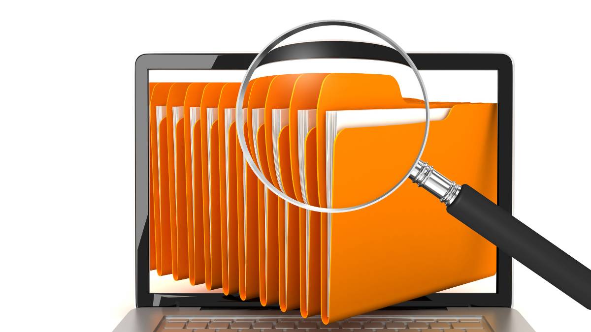 File-names-that-make-sense Magnifying glass hovering over a set of orange file folders