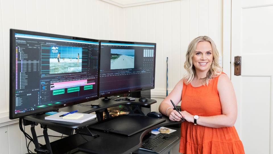 Managing-your-video-assets Female editor in front of video edit suite