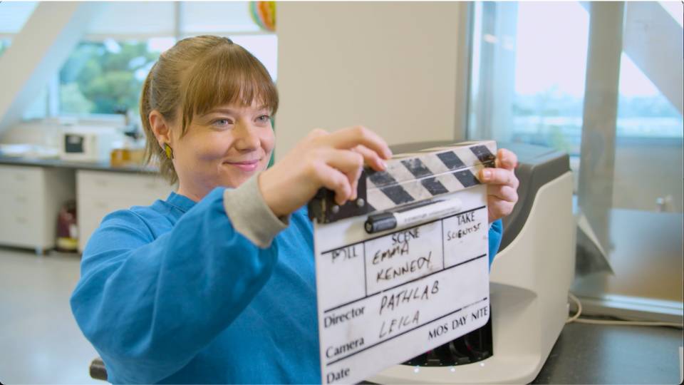 Contact 2 Scene from video production of a lab tech with a video clapper