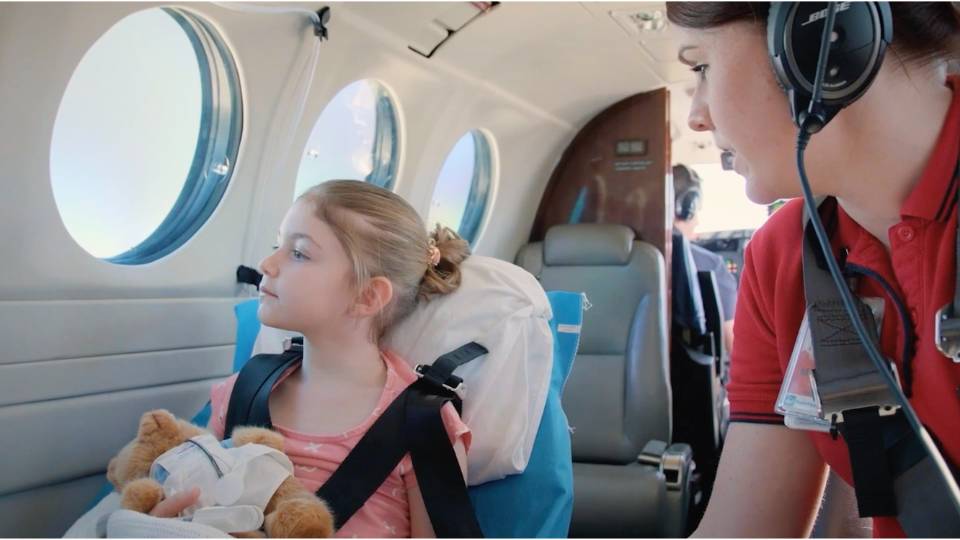 Client testimonials 5 Nurse and child inside royal flying doctors aeroplane