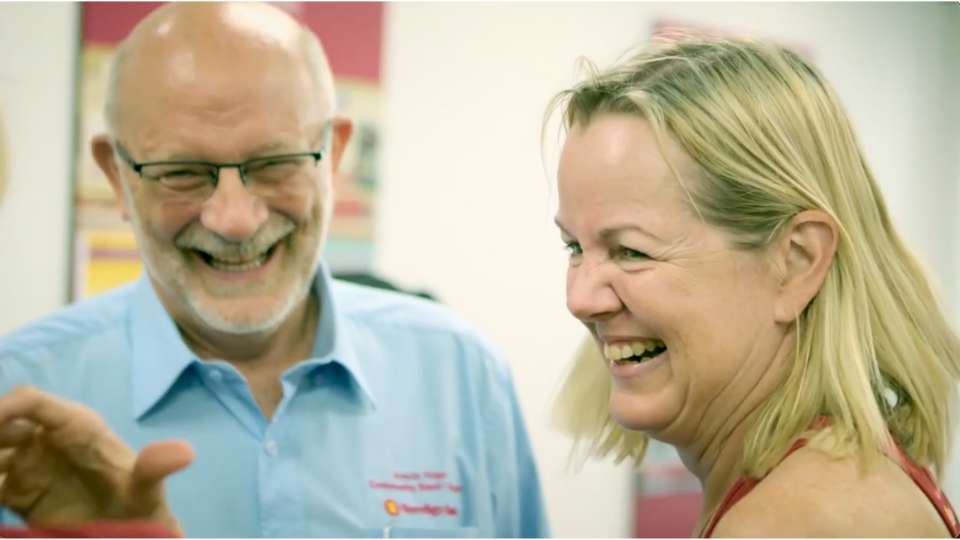 Client testimonials 30 Bank employee and customer laughing together