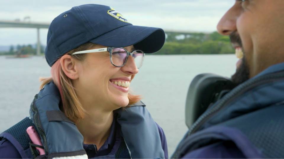Client testimonials 34 Male and female fisheries officers smiling together on a boat on brisbane river