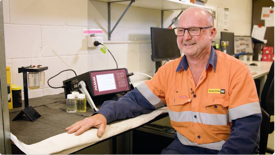 Corporate video production 3 Service technician sittinh at desk smiling
