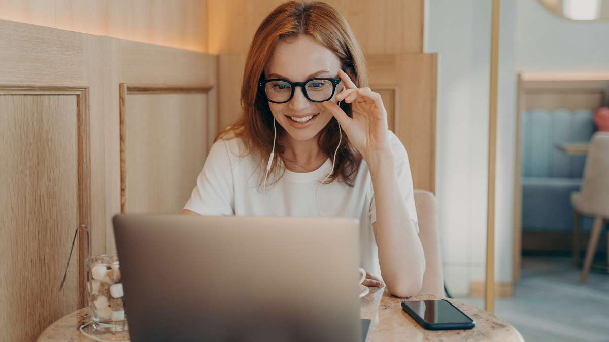 Add-video-to-proposals Woman watching a video within a digital proposal on laptop
