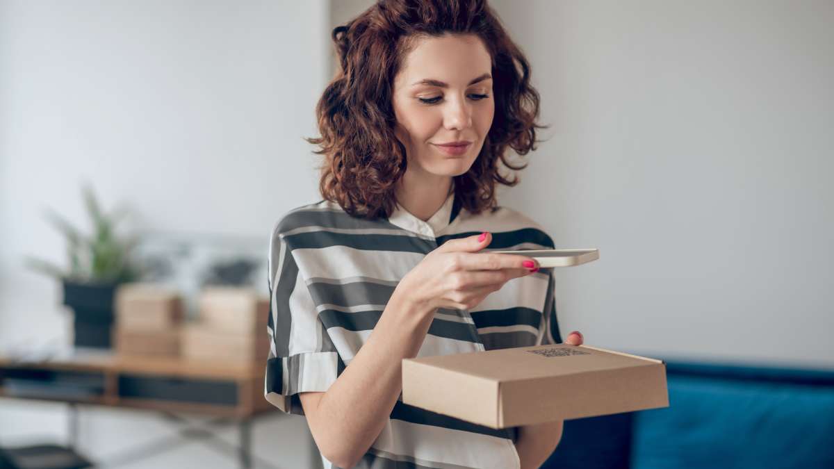 Boost-video-engagement-with-qr-code Woman scanning packaging qr code to watch video